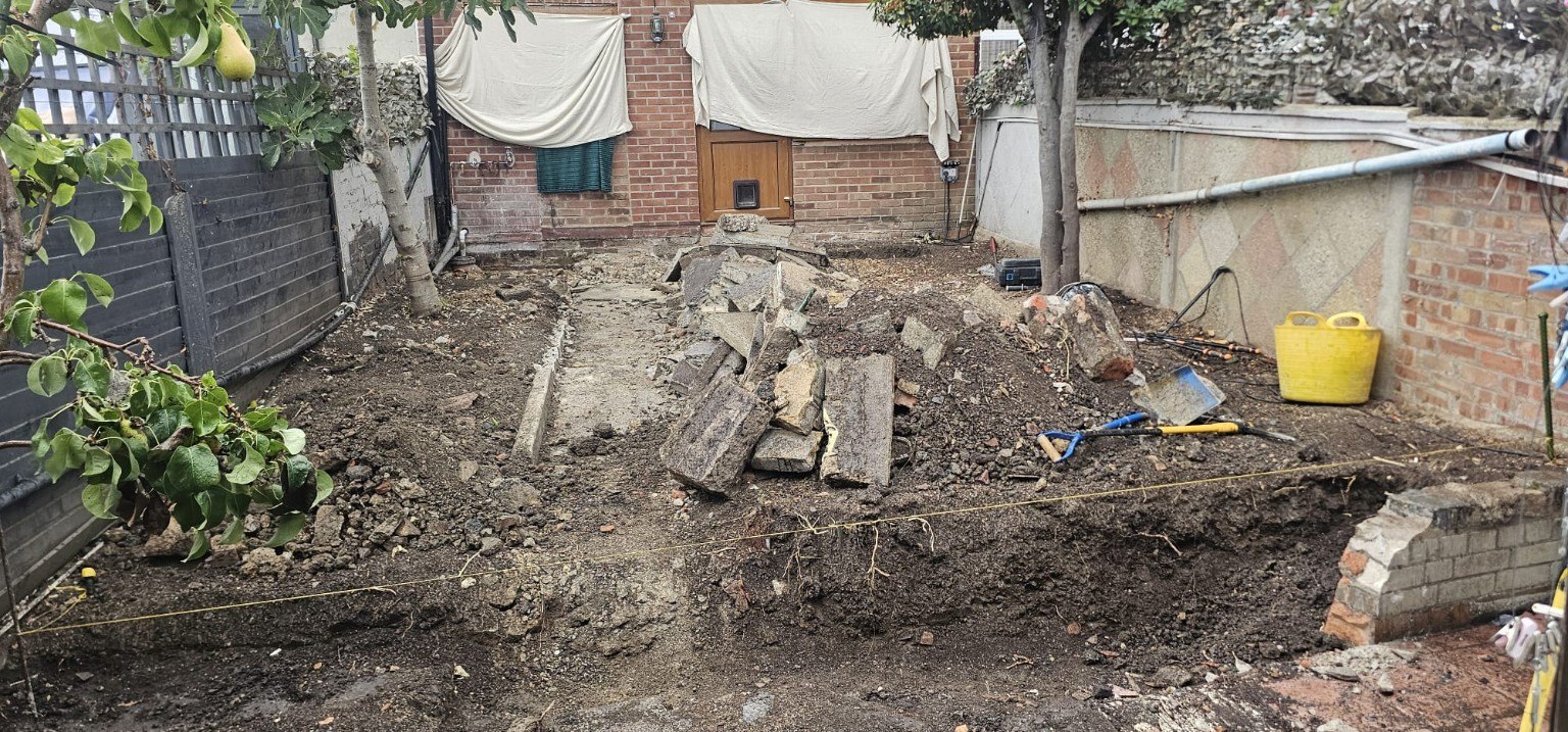 Garden before work, with the old surface cleared and ground prepared